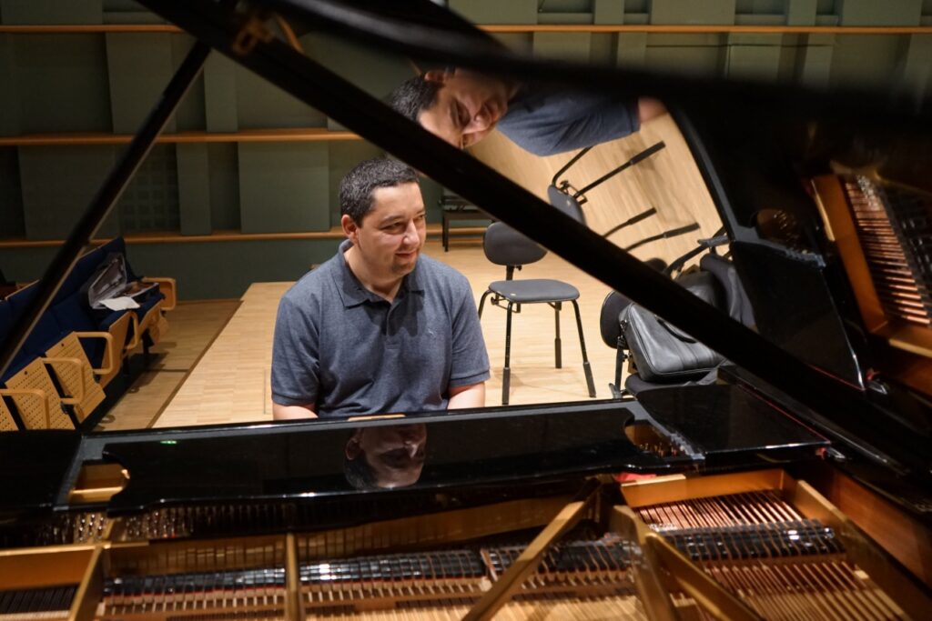 Pianisti József Balog istuu flyygelin ääressä.